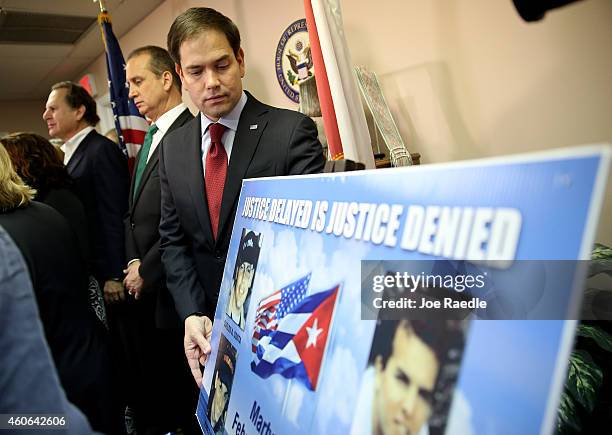 Sen. Marco Rubio stands near a poster with pictures of those lost from the group called "Brothers to the Rescue" when they were shot down by Cuban...