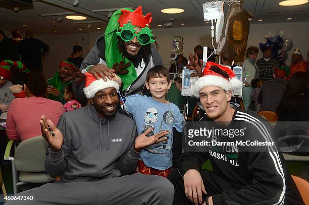 Boston Celtics Jeff Green, Gerald Wallace, and Dwight Powell spend time with Ryan at Boston Children's Hospital December 18, 2014 in Boston,...