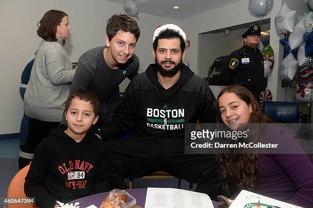 Boston Celtics Vitor Faverani spends time with Zackary, Guidian, and Arielle at Boston Children's Hospital December 18, 2014 in Boston, Massachusetts.