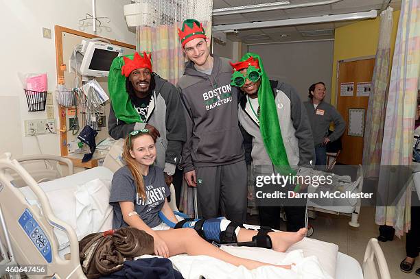 Boston Celtics Gerald Wallace, Tyler Zeller, and Marcus Smart visit with Gabriella at Boston Children's Hospital December 18, 2014 in Boston,...