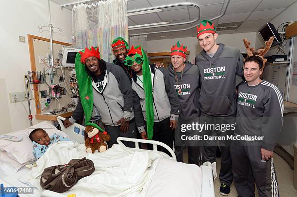 Boston Celtics Gerald Wallace, Walter McCarty, Marcus Smart, Jay Larranaga, Tyler Zeller, and Darren Erman spend time with David at Boston Children's...