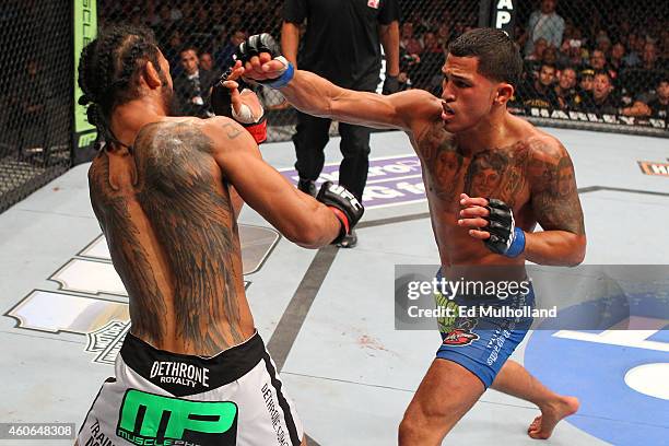 Anthony 'Showtime' Pettis punches Benson Henderson in their UFC lightweight championship bout at BMO Harris Bradley Center on August 31, 2013 in...