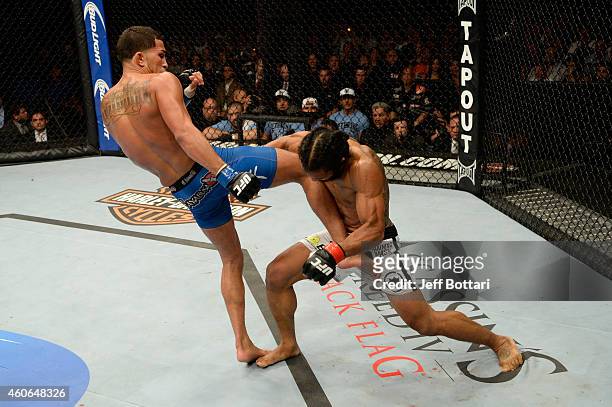 Anthony Pettis kicks Benson Henderson in their UFC lightweight championship bout at BMO Harris Bradley Center on August 31, 2013 in Milwaukee,...