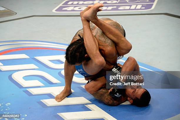 Anthony Pettis attempts to submit Benson Henderson in their UFC lightweight championship bout at BMO Harris Bradley Center on August 31, 2013 in...