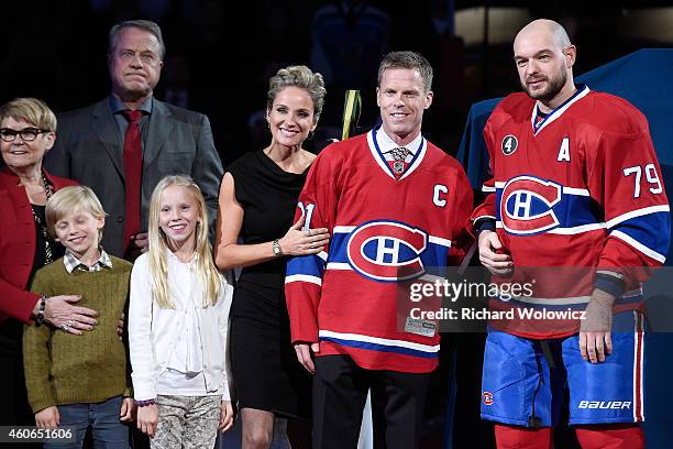 Former Montreal Canadien player Saku Koivu poses for a photo with family and former teammates during a ceremony honouring the former team captain...