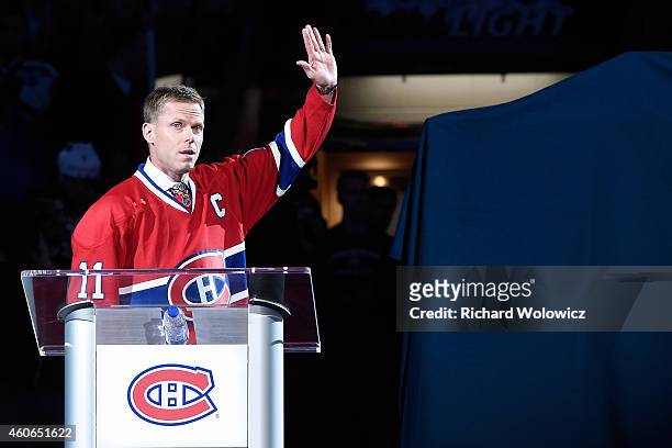 Former Montreal Canadien player Saku Koivu speaks to fans during a ceremony honouring the former team captain prior to the NHL game between the...