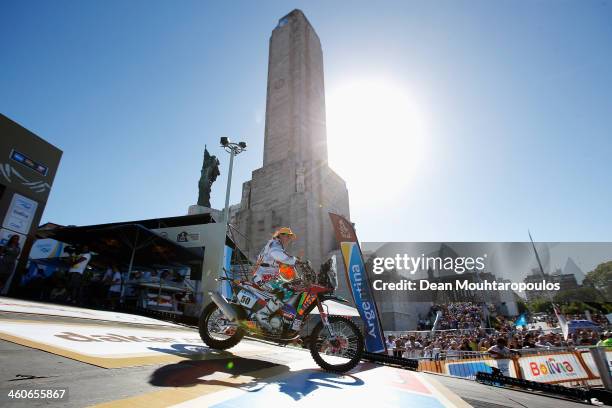 Laia Sanz of Spain for Honda Laia Sanz rides off the official podium in front of The National Flag Memorial during the 2014 Dakar Rally Previews on...