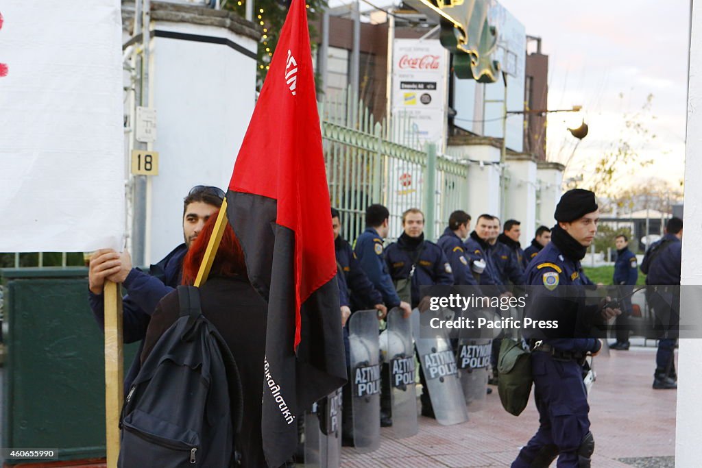 A sympathizer with a red and black Anarchist flag stands...