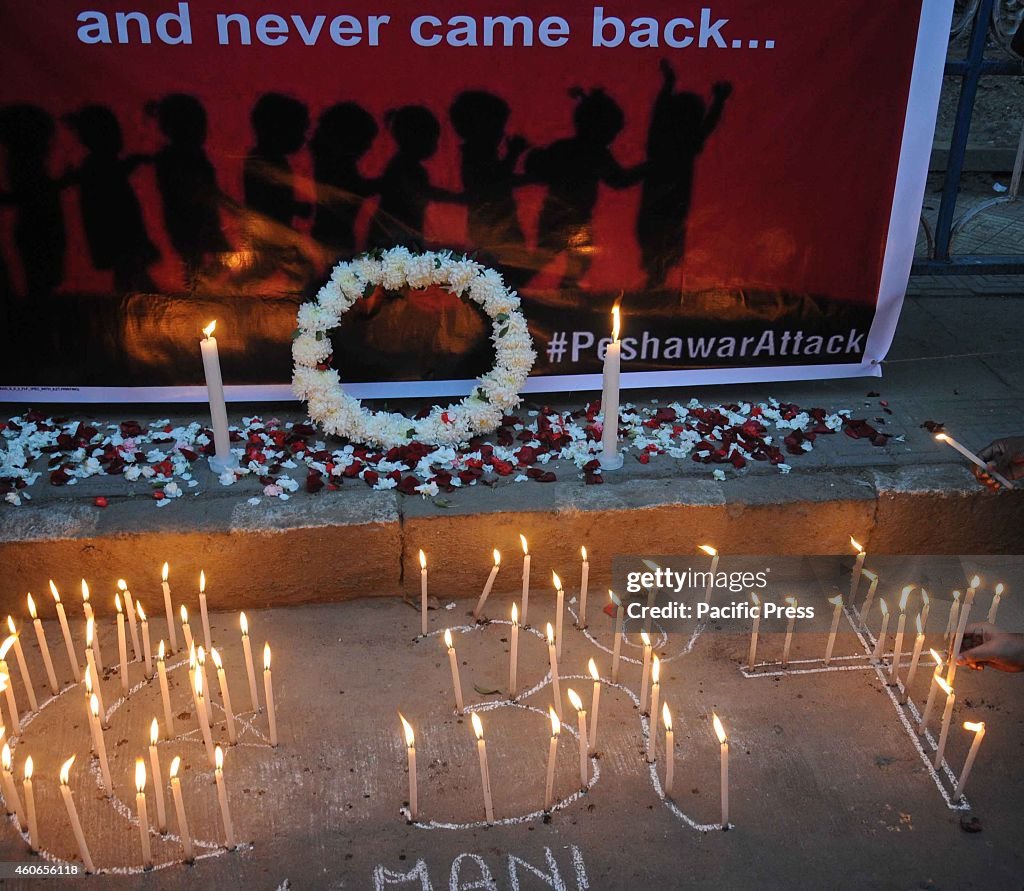 People take part in a candle light protest against the...