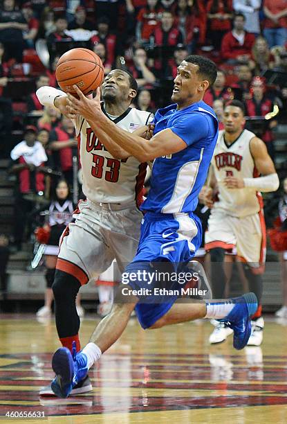 Deville Smith of the UNLV Rebels and Kamryn Williams of the Air Force Falcons go after an inbounds pass during their game at the Thomas & Mack Center...