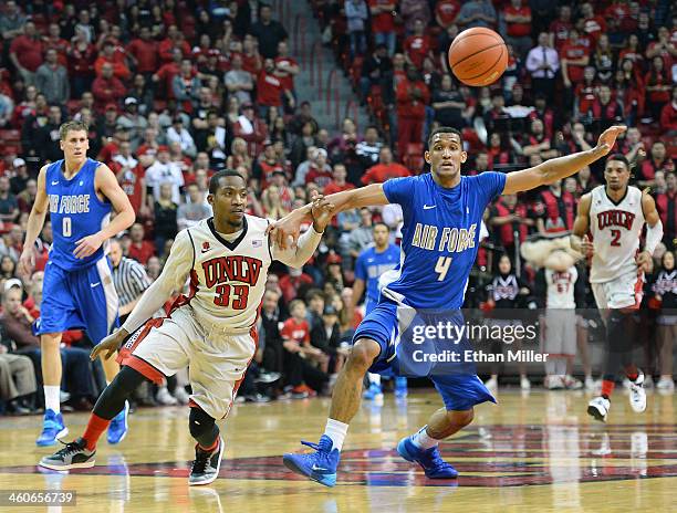 Deville Smith of the UNLV Rebels and Kamryn Williams of the Air Force Falcons go after an inbounds pass during their game at the Thomas & Mack Center...