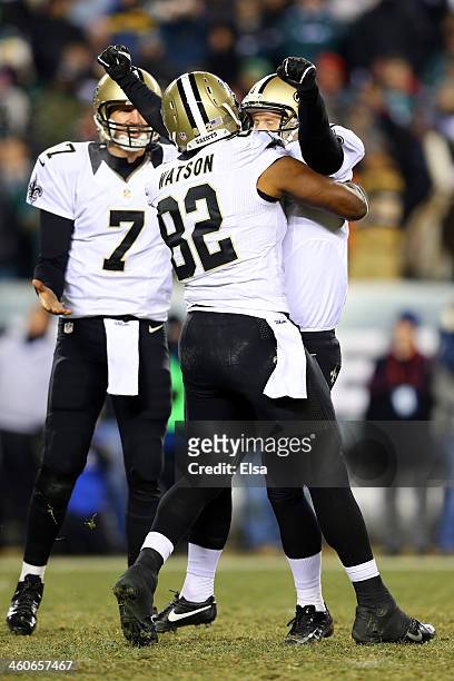 Shayne Graham of the New Orleans Saints celebrates with teammate Benjamin Watson after kicking the game winning field goal to defeat the Philadelphia...