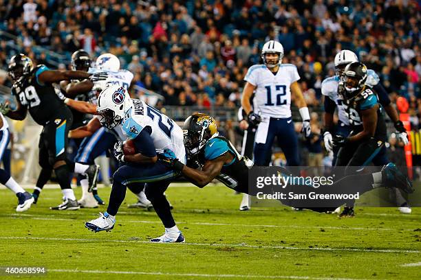 Leon Washington of the Tennessee Titans is tackled by Craig Loston of the Jacksonville Jaguars in the fourth quarter at EverBank Field on December...