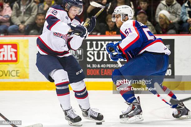 Tye Felhaber of the Saginaw Spirit moves the puck against Jalen Chatfield of the Windsor Spitfires on December 18, 2014 at the WFCU Centre in...