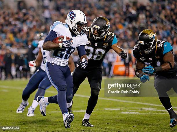 Leon Washington of the Tennessee Titans carries as Tommie Campbell and Jeremiah George of the Jacksonville Jaguars defend during the game at EverBank...