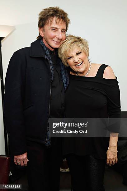 Singer Barry Manilow poses for a photo with singer/ actress Lorna Luft backstage following her performance at 54 Below on December 18, 2014 in New...