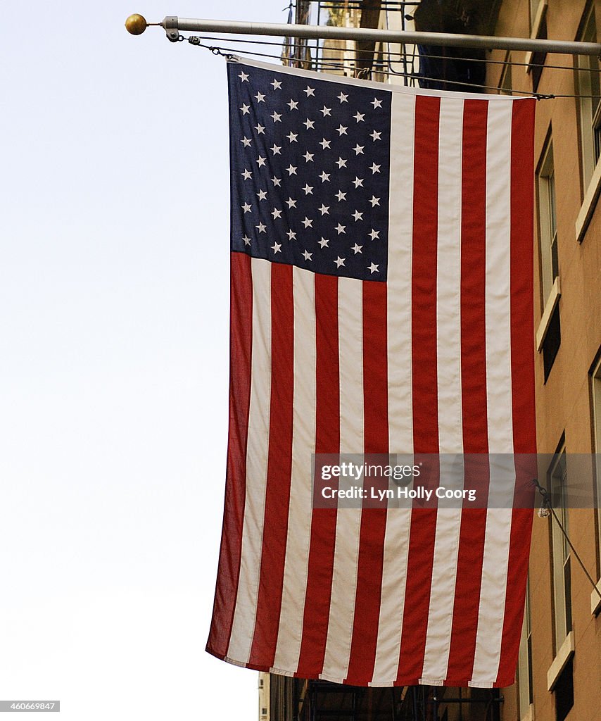 Close up of American flag hanging from building