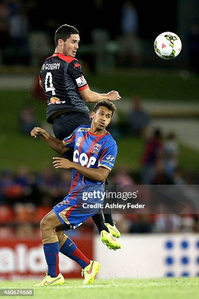 Cameron Watson of Adelaide United contests the header against Mitch Cooper of the Jets during the round 12 A-League match between the Newcastle Jets...