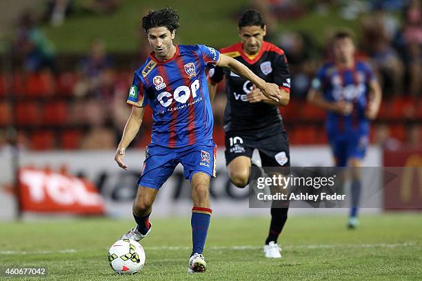 Zenon Caravella of the Jets controls the ball ahead of Adelaide United defence during the round 12 A-League match between the Newcastle Jets and...