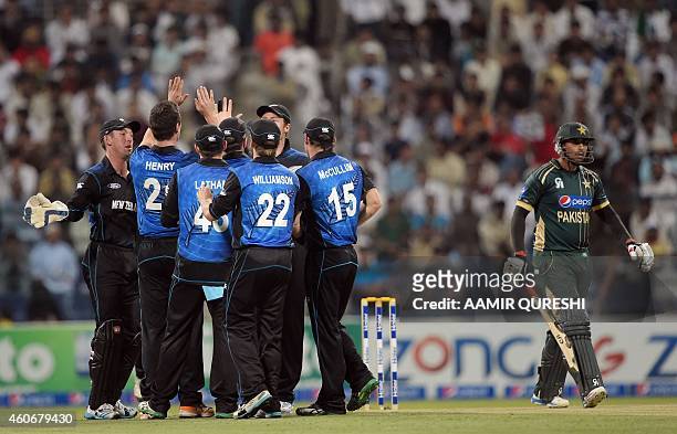New Zealand cricketers celebrate after the dismissal of Pakistani batsman Nasir Jamshed during the fifth and final day-night international match...