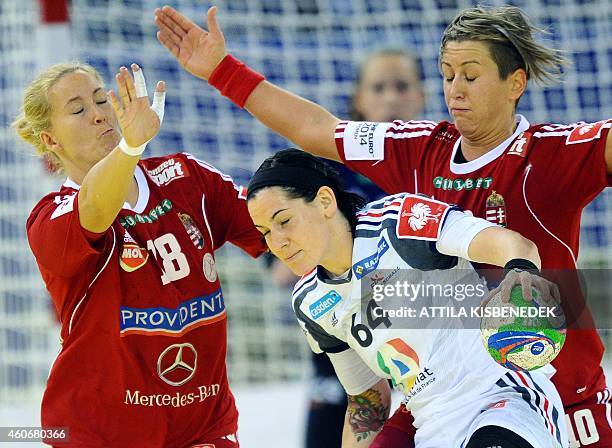 France 's Alexandra Lacrabere fights for the ball with Hungary's Piroska Szamoransky and Anita Bulath in Papp Laszlo Arena of Budapest on December...