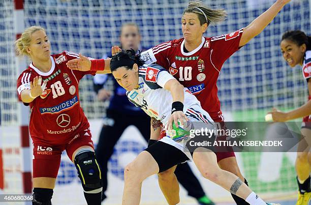 France 's Alexandra Lacrabere fights for the ball with Hungary's Piroska Szamoransky and Anita Bulath in Papp Laszlo Arena of Budapest on December...