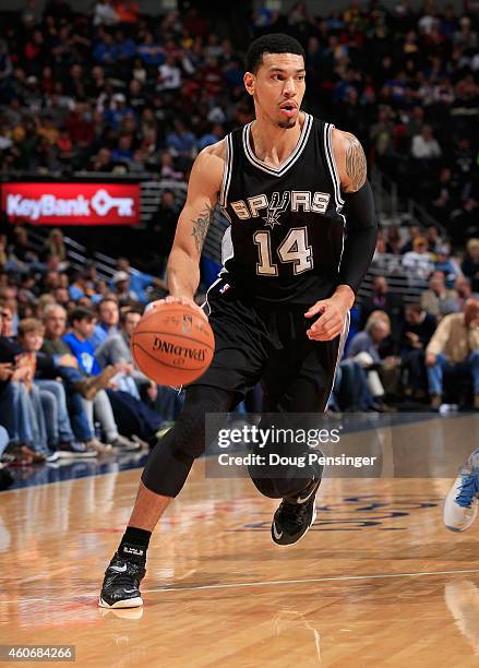 Danny Green of the San Antonio Spurs controls the ball against the Denver Nuggets at Pepsi Center on December 14, 2014 in Denver, Colorado. The Spurs...