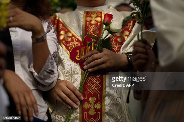 Catholic priest, Michael Chua holds roses as he poses for pictures with Malaysian activists in front of the Church of Our Lady of Lourdes during a...