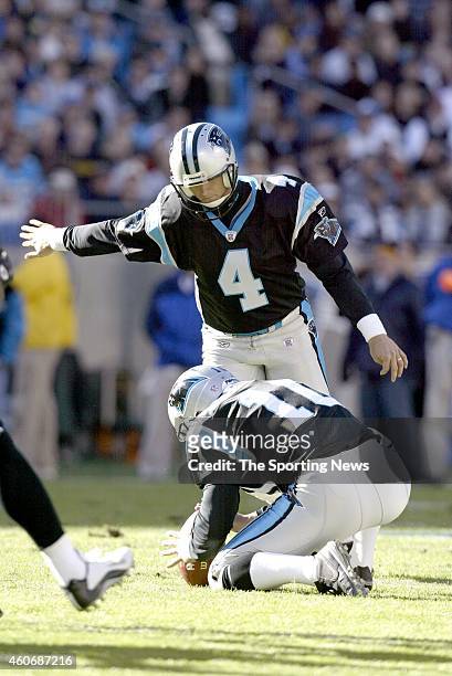 John Kasay of the Carolina Panthers kicks a field goal on hold by Todd Sauerbrun during a game against the Philadelphia Eagles on November 30, 2003...