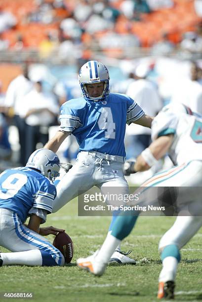 Jason Hanson of the Detroit Lions kicks a field goal on hold by John Jett during a game against the Miami Dolphins on September 8, 2002 at the Pro...