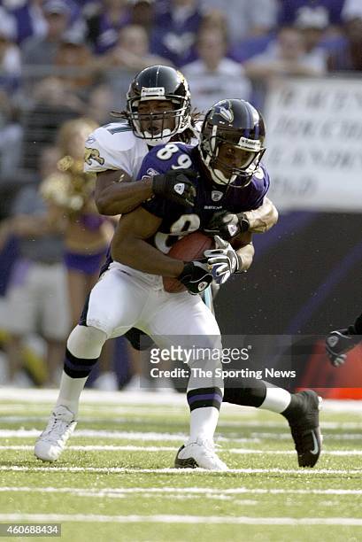 Travis Taylor of the Baltimore Ravens is tackled by Rashean Mathis of the Jacksonville Jaguars during a game on October 26, 2003 at the Raymond James...