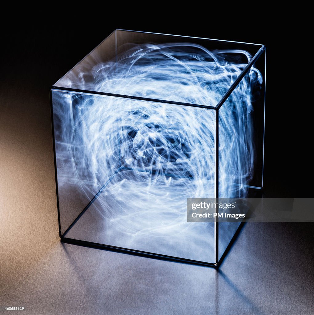 Trails of blue light in clear box