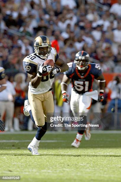 Isaac Bruce of the St. Louis Rams runs with the ball during a game against the Denver Broncos on September 8, 2002 at Sports Authority Field at Mile...