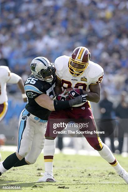 Dan Morgan of the Carolina Panthers makes a tackle during a game against the Washington Redskins on November 16, 2003 at Ericsson Stadium in...