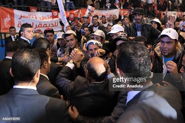 Tunisian presidential candidate Moncef Marzouki greets his supporters during his election campaign within the 2nd round of the presidential election...