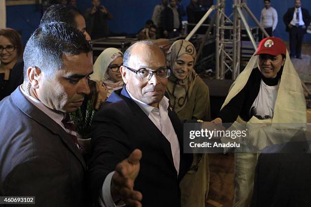 Tunisian presidential candidate Moncef Marzouki greets his supporters during his election campaign within the 2nd round of the presidential election...