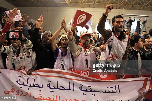Supporters of Tunisian presidential candidate Moncef Marzouki shout slogans during Marzouki's election campaign within the 2nd round of the...