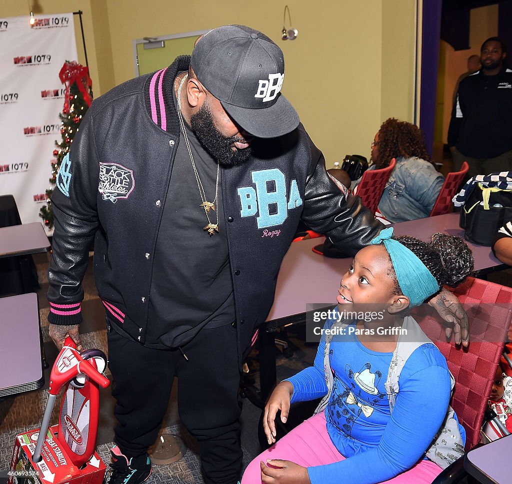 Rick Ross Surprises Atlanta Families With Holiday Gifts