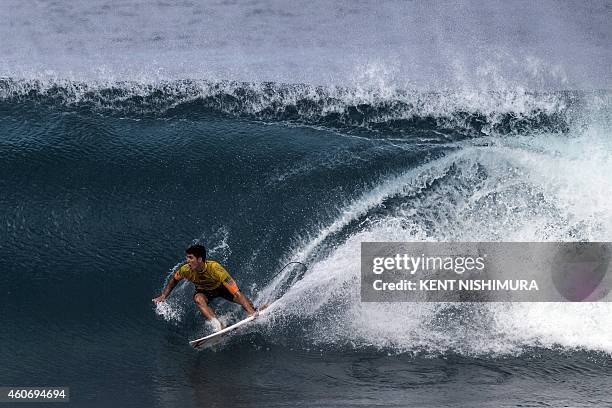 Brazil's Gabriel Medina rides a wave during Round 4, heat 2 of the final day of the Billabong Pipeline Masters event of the Vans Triple Crown of...