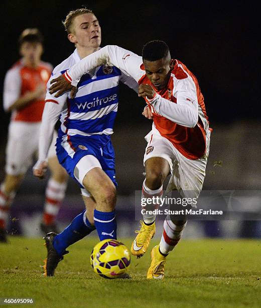 Tyrell Robinson of Arsenal breaks past Jake Sheppard of Reading during the FA Youth Cup 3rd Round match between Arsenal and Reading at Meadow Park on...