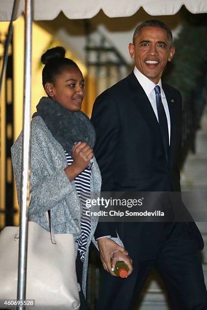 President Barack Obama and his daughter Sasha Obama leave the White House for their holiday vacation December 19, 2014 in Washington, DC. The first...