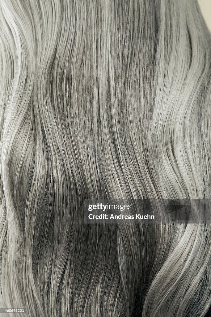 Close up of wavy, long, silver gray hair.