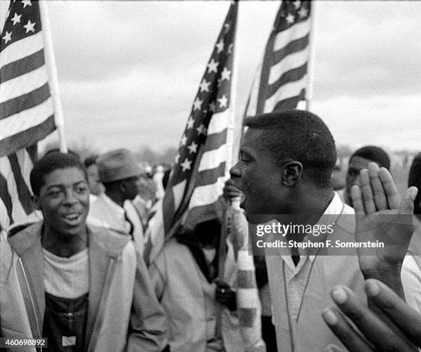 Young African-American civil rights marchers singing as they marched along the road on the 1965 Selma to Montgomery civil rights march. On March 25,...