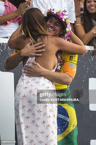 Lyndie Irons, widow of the late Andy Irons , hugs Brazil's Gabriel Medina at the awards ceremony on the final day of the Billabong Pipeline Masters...