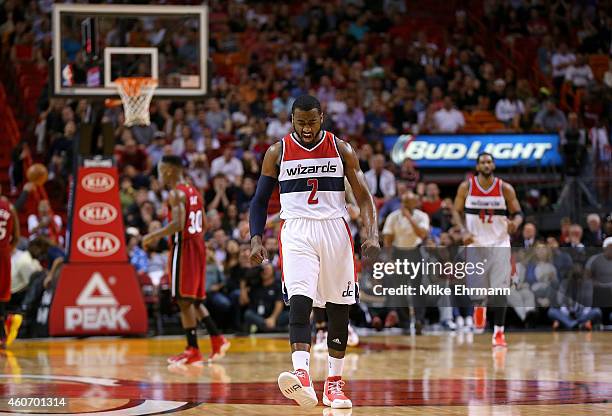 John Wall of the Washington Wizards reacts to a late fourth quarter 3 pointer during a game against the Miami Heat at American Airlines Arena on...