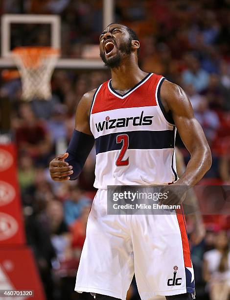 John Wall of the Washington Wizards reacts to a late fourth quarter 3 pointer during a game against the Miami Heat at American Airlines Arena on...