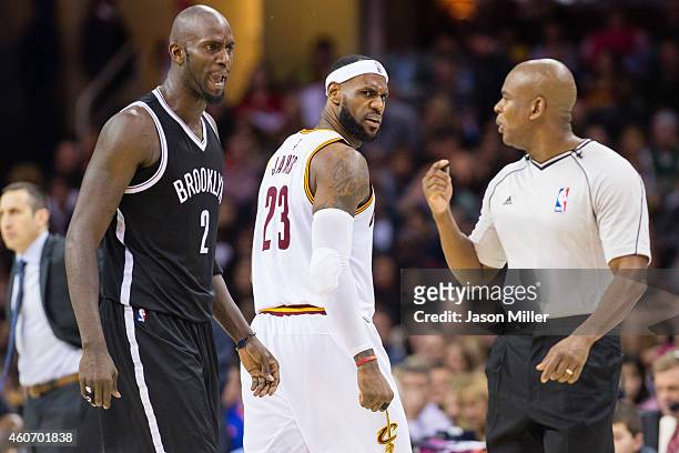 Kevin Garnett of the Brooklyn Nets and LeBron James of the Cleveland Cavaliers yell at official Sean Wright during the second half at Quicken Loans...