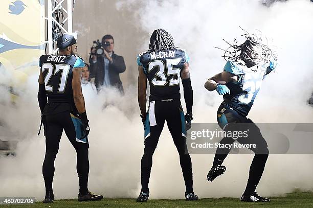 Johnathan Cyprien takes the field with Dwayne Gratz and Demetrius McCray of the Jacksonville Jaguars prior to a game against the Tennessee Titans at...