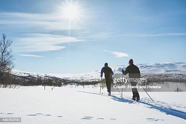 two senior men cross country skiing, hermavan, sweden - hemavan stock pictures, royalty-free photos & images