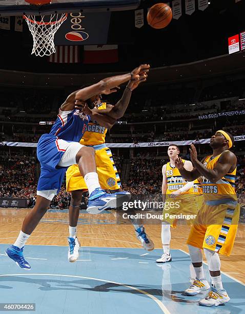 DeAndre Jordan of the Los Angeles Clippers commits a flagrant foul against Kenneth Faried of the Denver Nuggets in the fourth quarter at Pepsi Center...